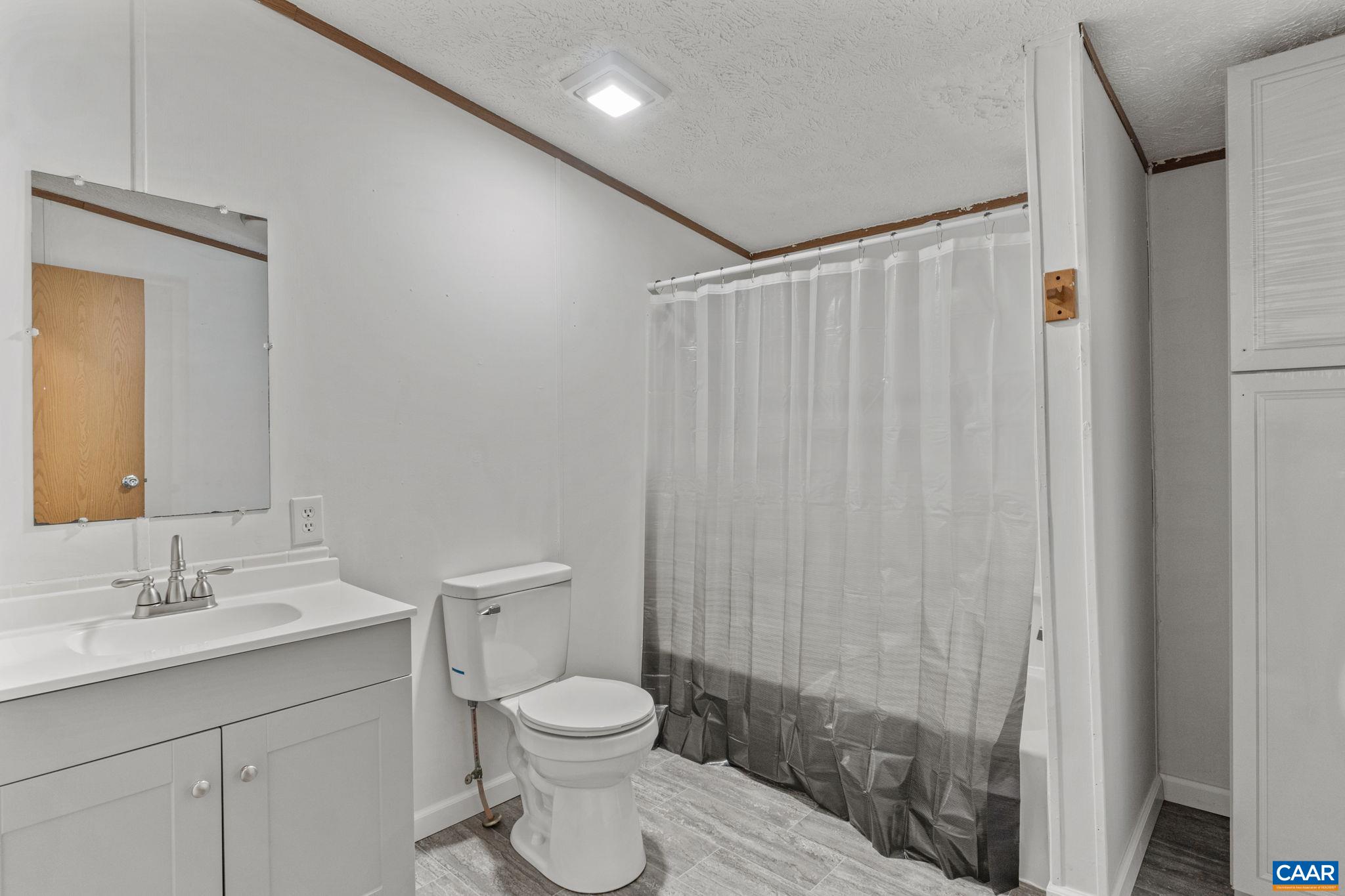 1990 Seven Eleven Road Cumberland, VA 23040 - Photo 17 of 21 a bathroom with a toilet a sink and a shower