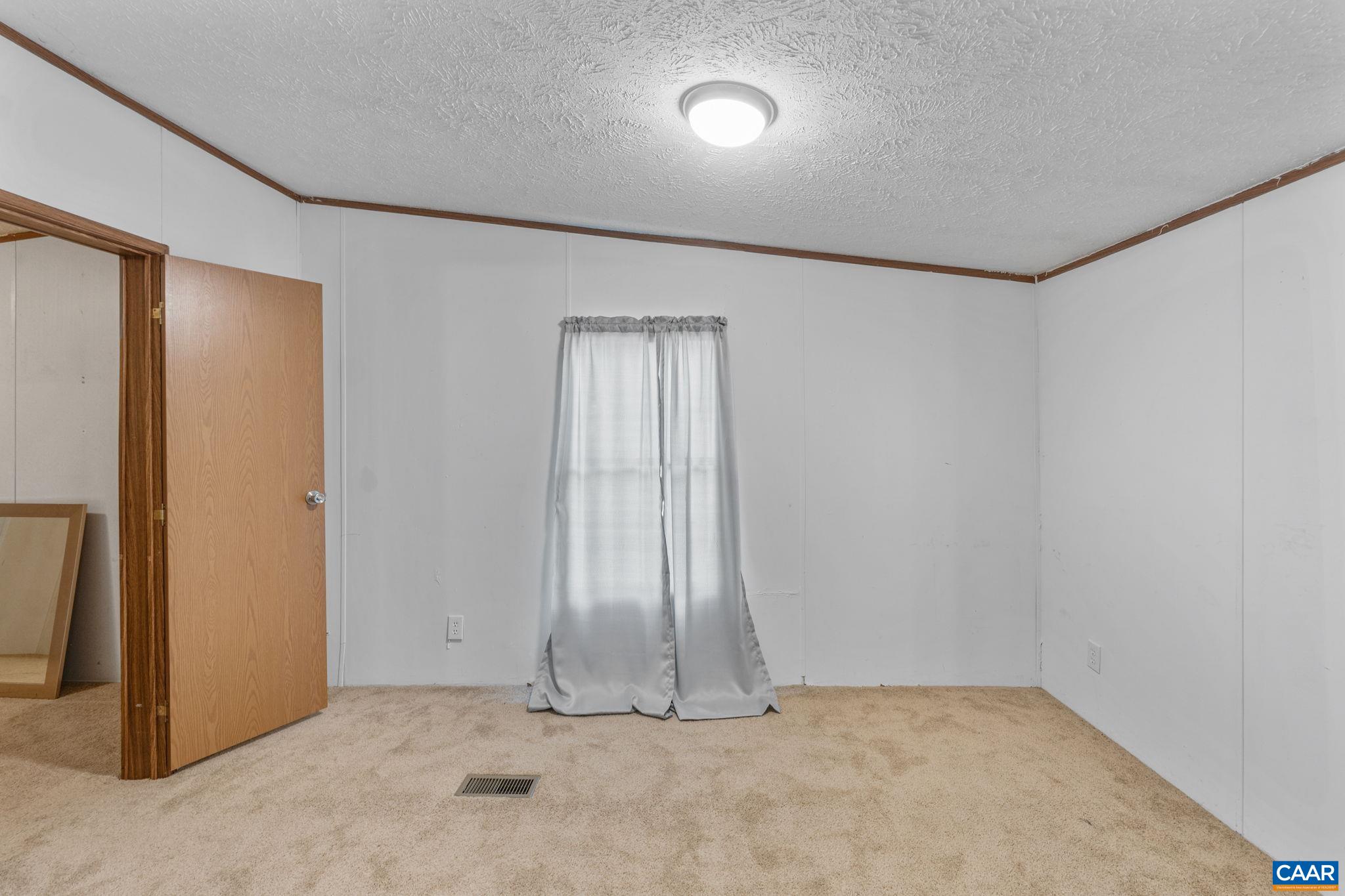 1990 Seven Eleven Road Cumberland, VA 23040 - Photo 8 of 21 an empty room with a door