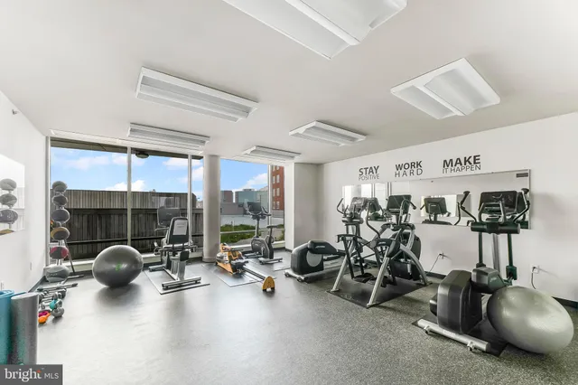 a room with gym equipment and floor to ceiling window