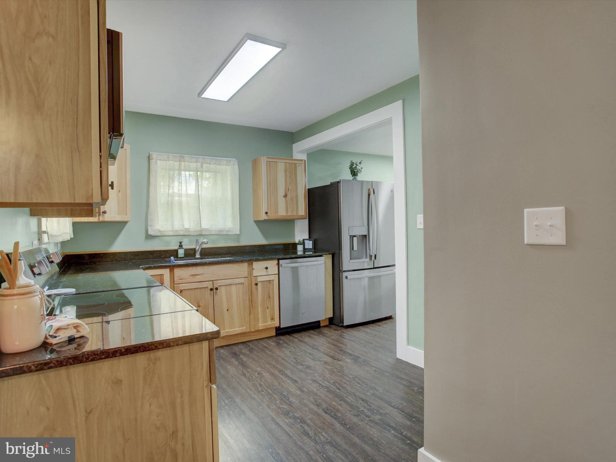 3043 Emmitsburg Road Gettysburg, PA 17325 - Photo 11 of 48 a kitchen with a sink a refrigerator and cabinets