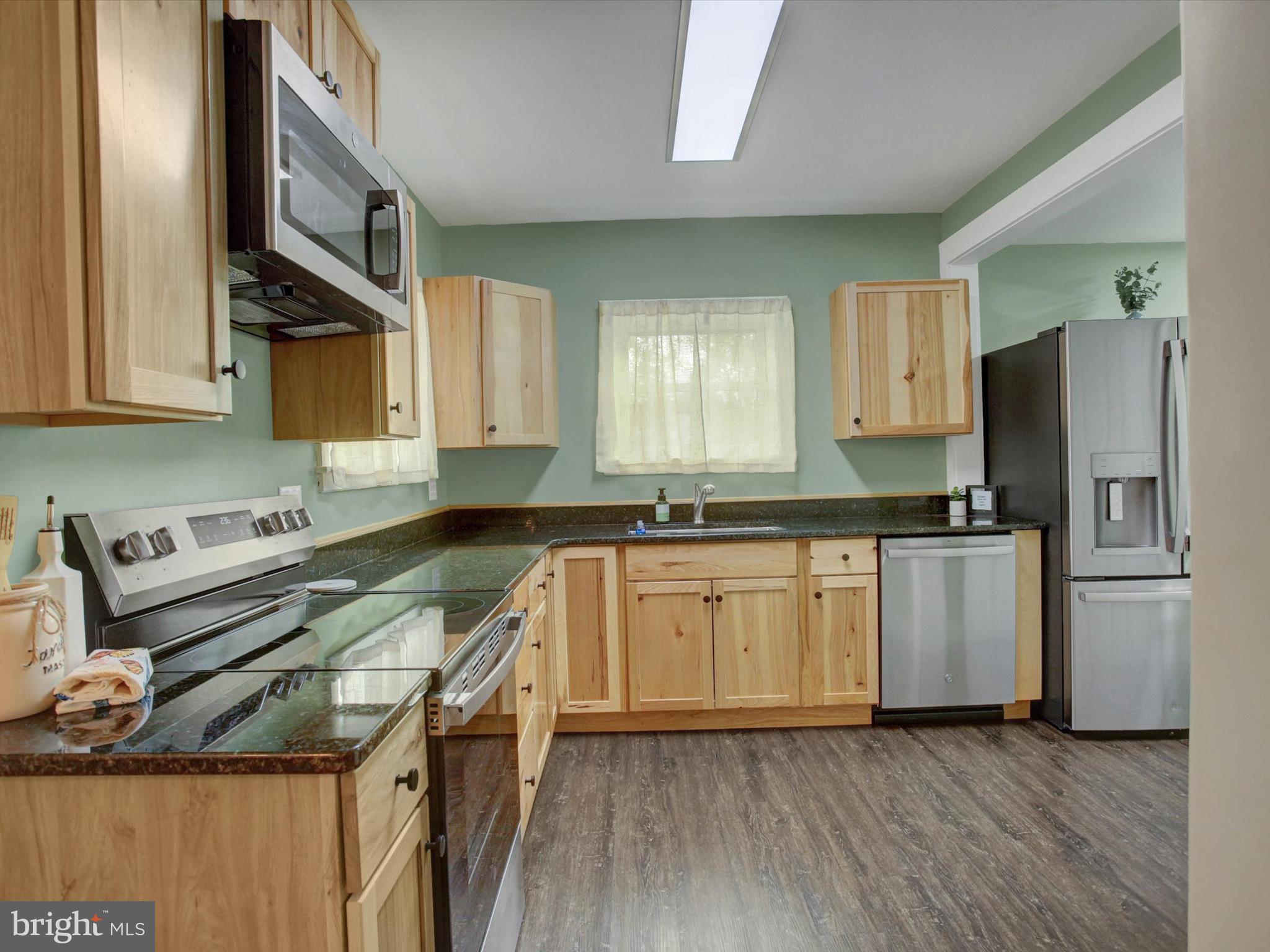 3043 Emmitsburg Road Gettysburg, PA 17325 - Photo 9 of 48 a kitchen with a stove a sink and a refrigerator