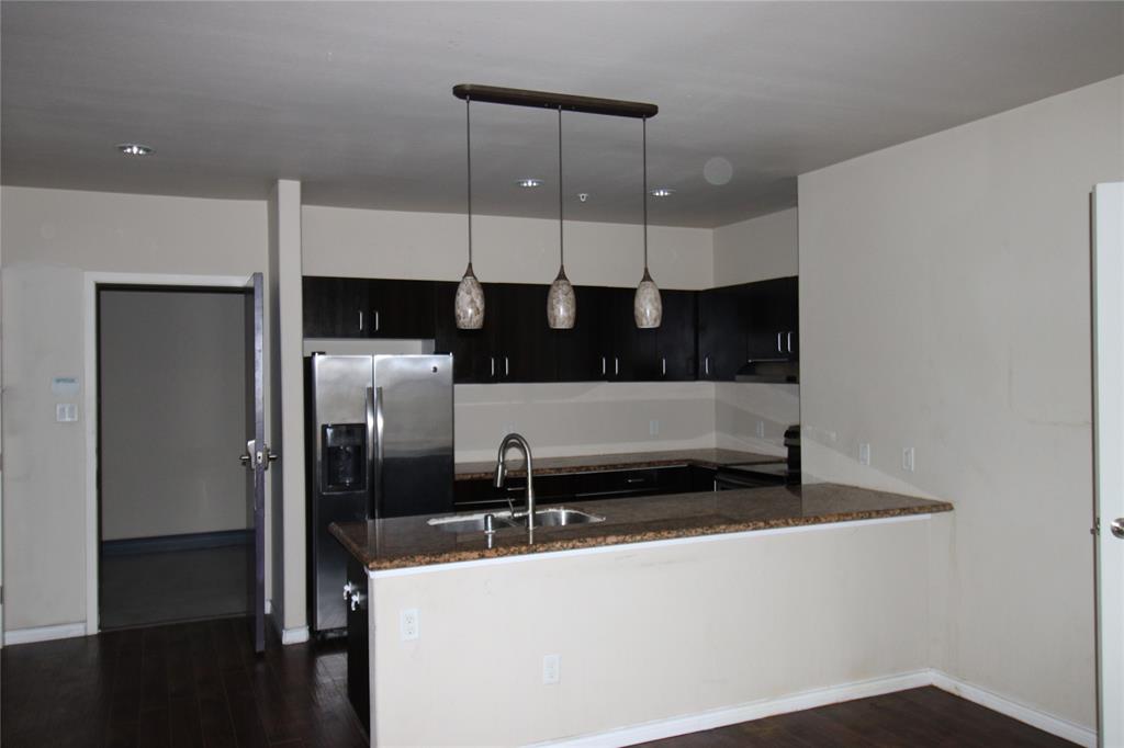 1100 West Trinity Mills Road, Unit 3035 Carrollton, TX 75006 - Photo 7 of 12 a kitchen with stainless steel appliances a refrigerator and a sink