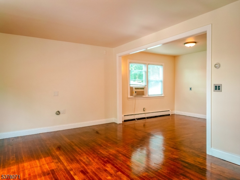 104 Eastern Way, Unit 2 Rutherford, NJ 07070 - Photo 2 of 18 an empty room with wooden floor and windows