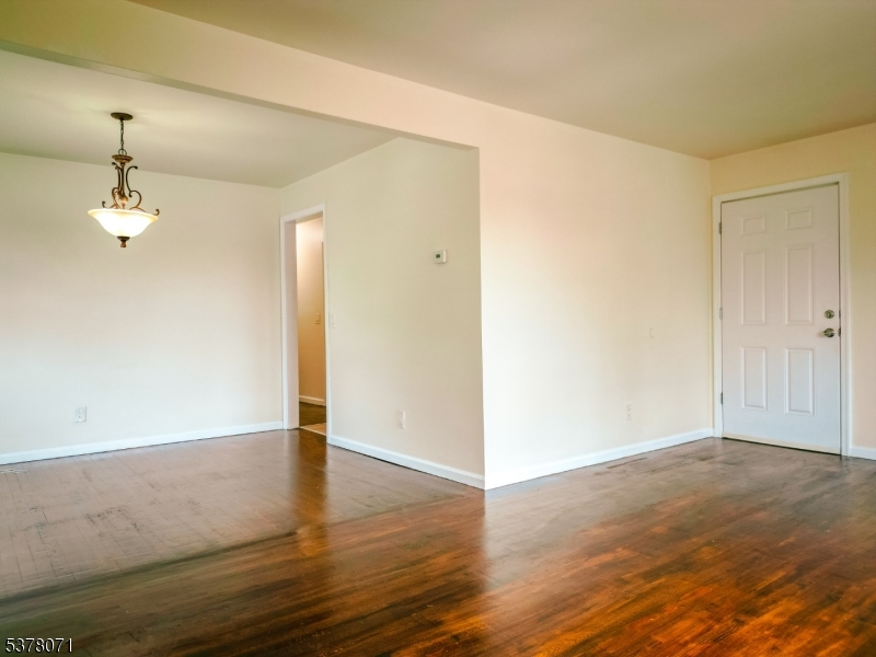 104 Eastern Way, Unit 2 Rutherford, NJ 07070 - Photo 8 of 18 an empty room with wooden floor and windows