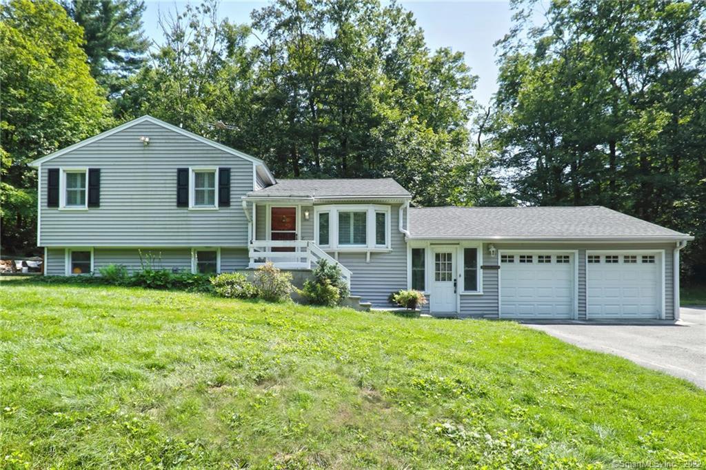 48 Cheshire Road Bethany, CT 06524 - Photo 1 of 1 a front view of a house with a yard and porch