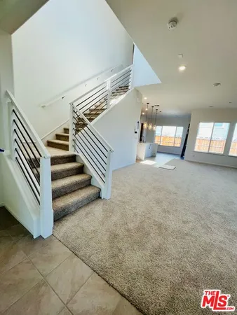 a view of a hallway to a room and window
