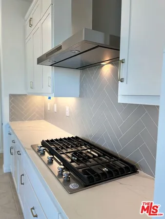 a spacious bathroom with a granite countertop sink mirror and a