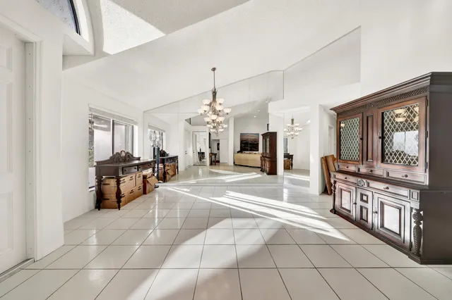 a lobby with furniture and chandelier