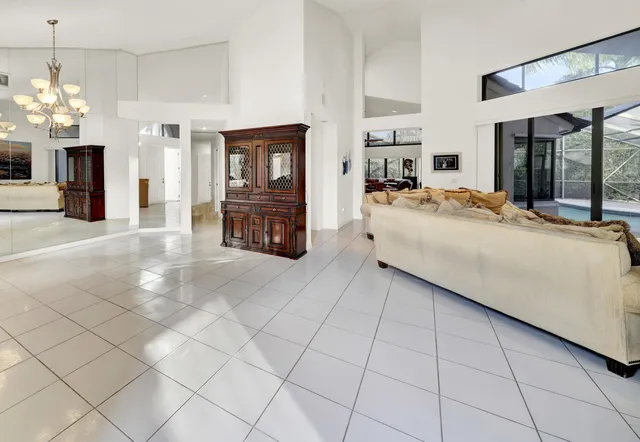 a living room with furniture and a chandelier
