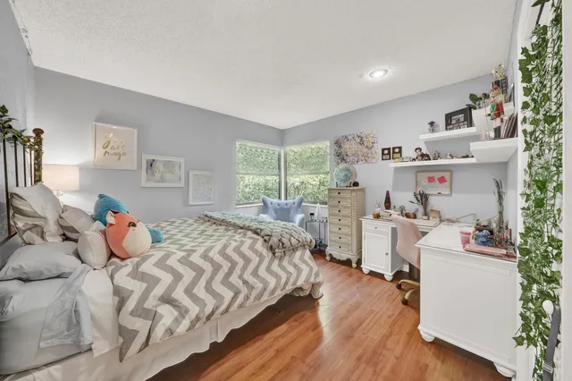 a bedroom with a bed and a large window