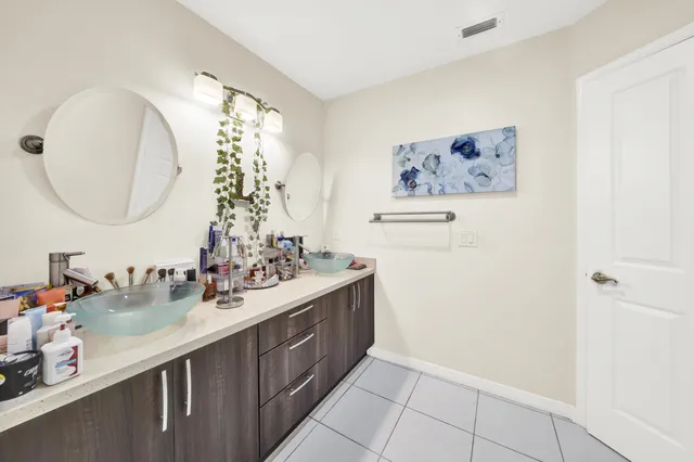 a bathroom with a double vanity sink and a mirror