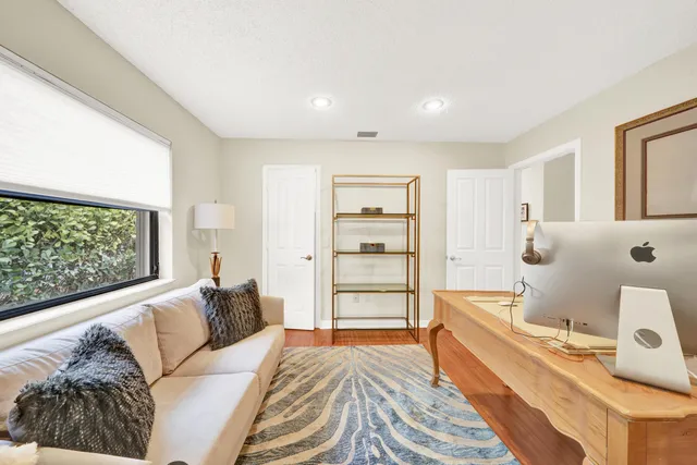 a bedroom with a bed and a large window