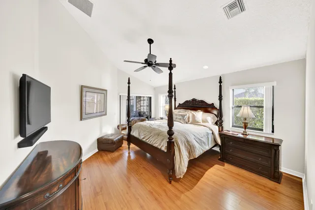 a bedroom with a bed window and a flat screen tv