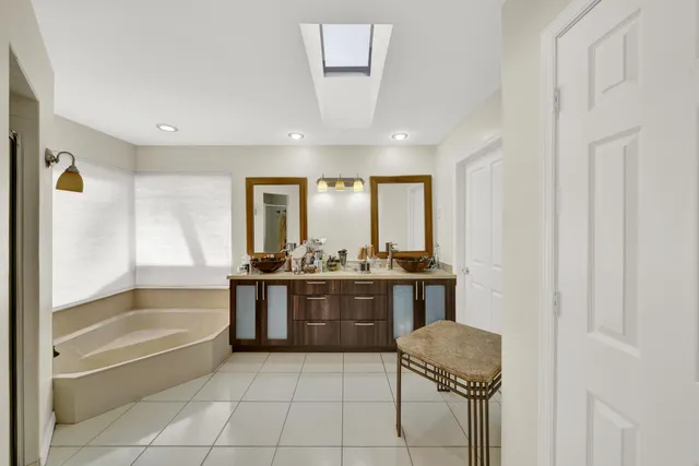 a bathroom with a granite countertop sink a toilet and bathtub