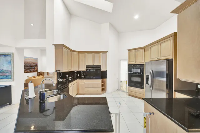 a large kitchen with a large counter top appliances and cabinets