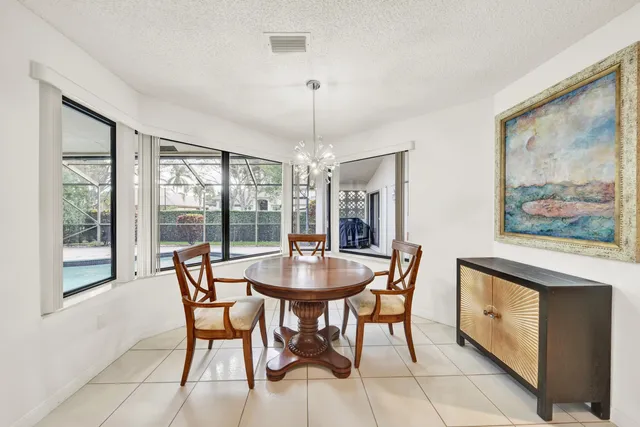 a dining room with furniture a chandelier and window