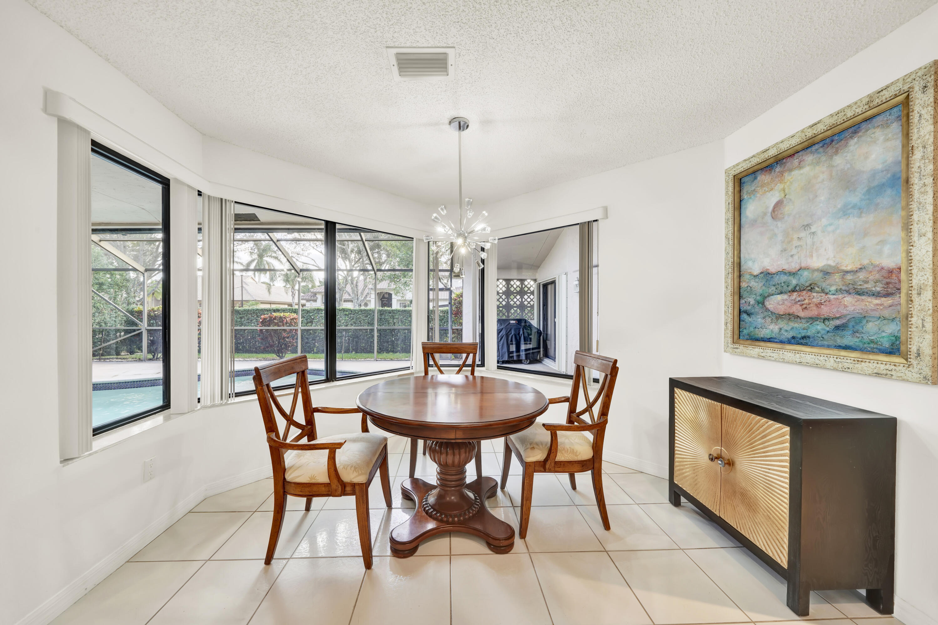 20513 Sausalito Drive Boca Raton, FL 33498 - Photo 9 of 39 a dining room with furniture a chandelier and window