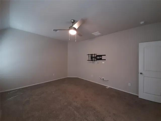 an empty room with a empty space and a ceiling fan