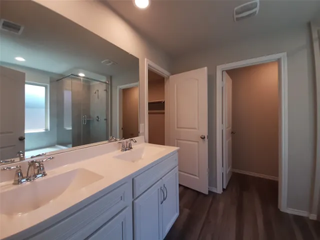 a bathroom with a double vanity sink and mirror