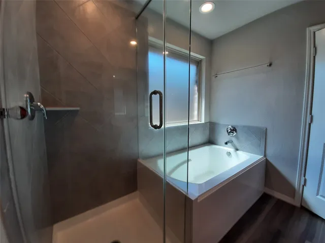 a bathroom with a tub and a sink