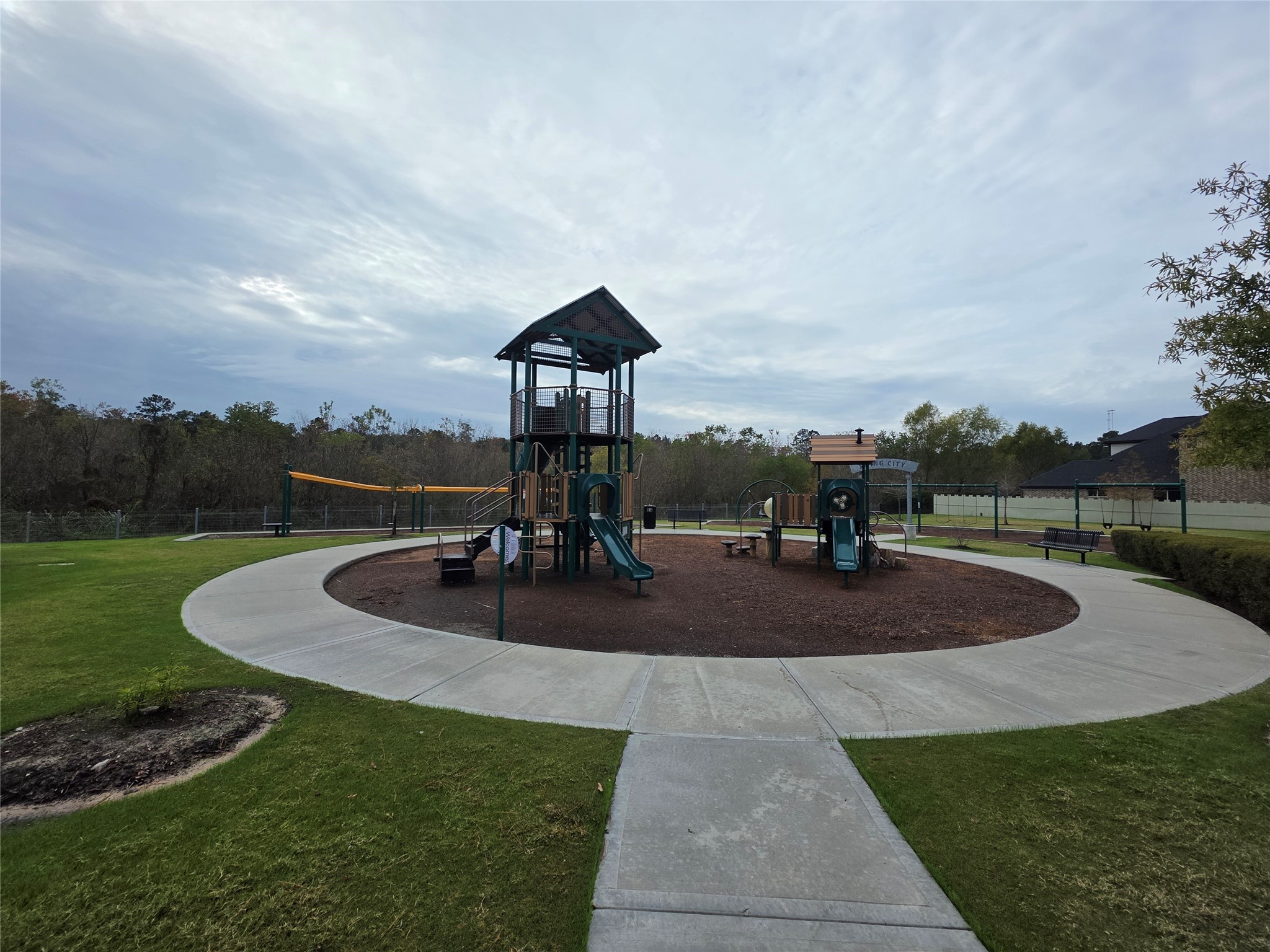 9257 Inland Leather Lane Conroe, TX 77385 - Photo 28 of 28 a front view of a house with garden