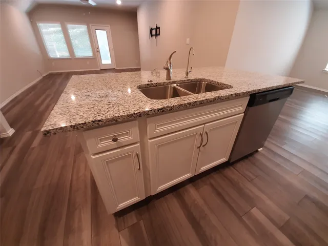 a kitchen with sink and mirror