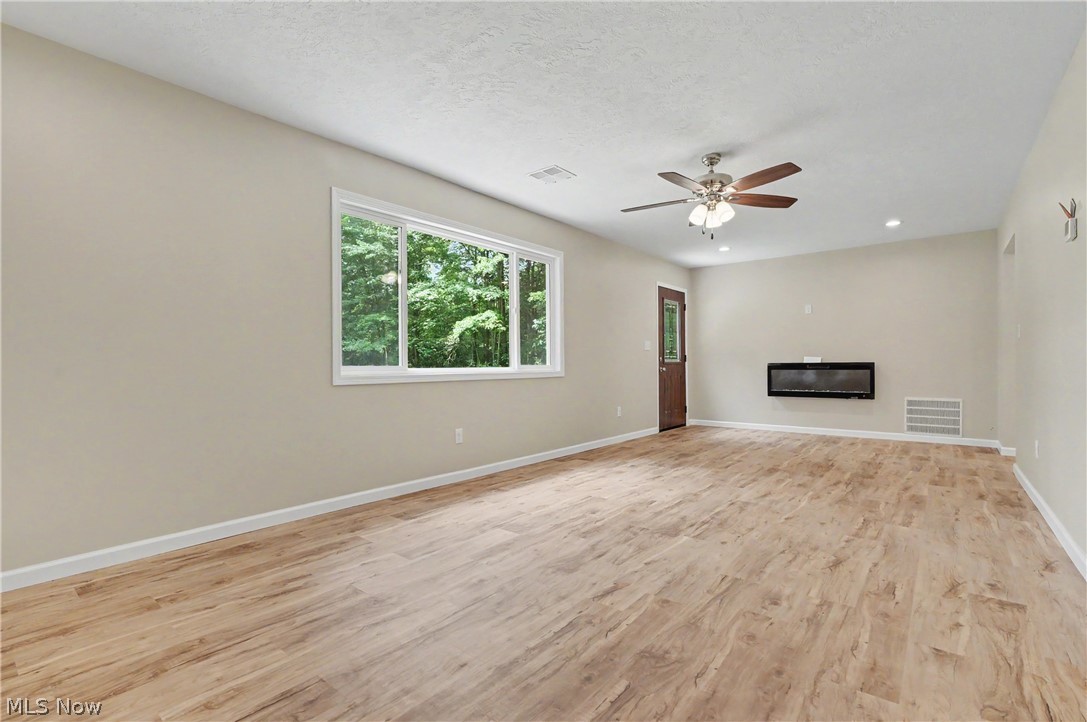 7583 Yale Road Atwater, OH 44201 - Photo 11 of 41 Large open living room with fireplace. New large picture window provides natural sunlight.