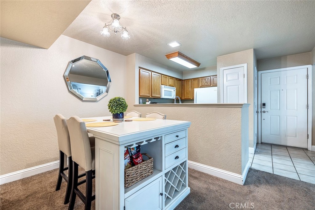 2881 Huntington Boulevard, Unit 137 Fresno, CA 93721 - Photo 14 of 30 a kitchen with a stove a refrigerator and a table