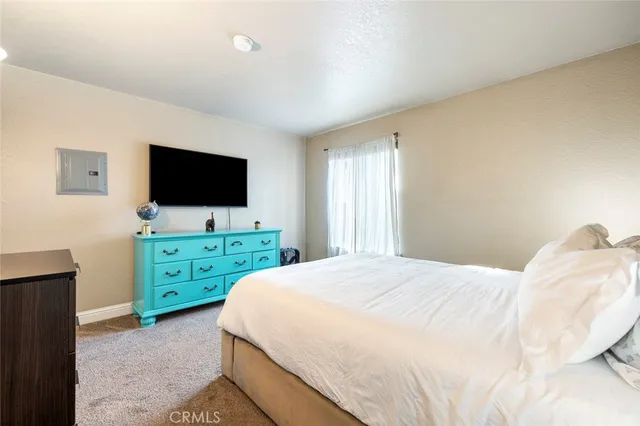 a bedroom with a bed and a flat screen tv