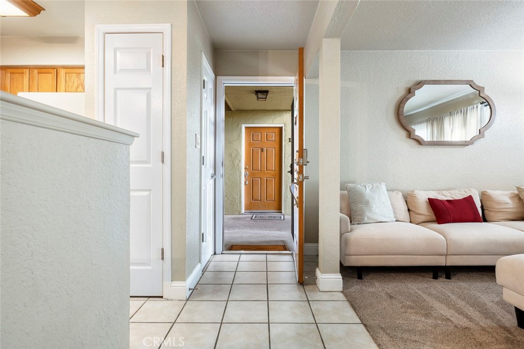 2881 Huntington Boulevard, Unit 137 Fresno, CA 93721 - Photo 2 of 30 a living room with a mirror and a glass door shower