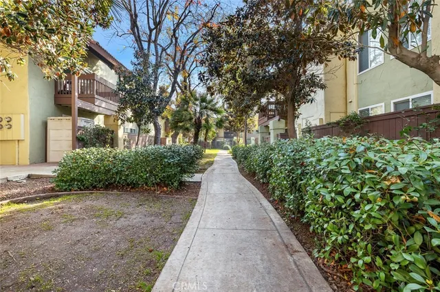 a view of a pathway with a wrought fence