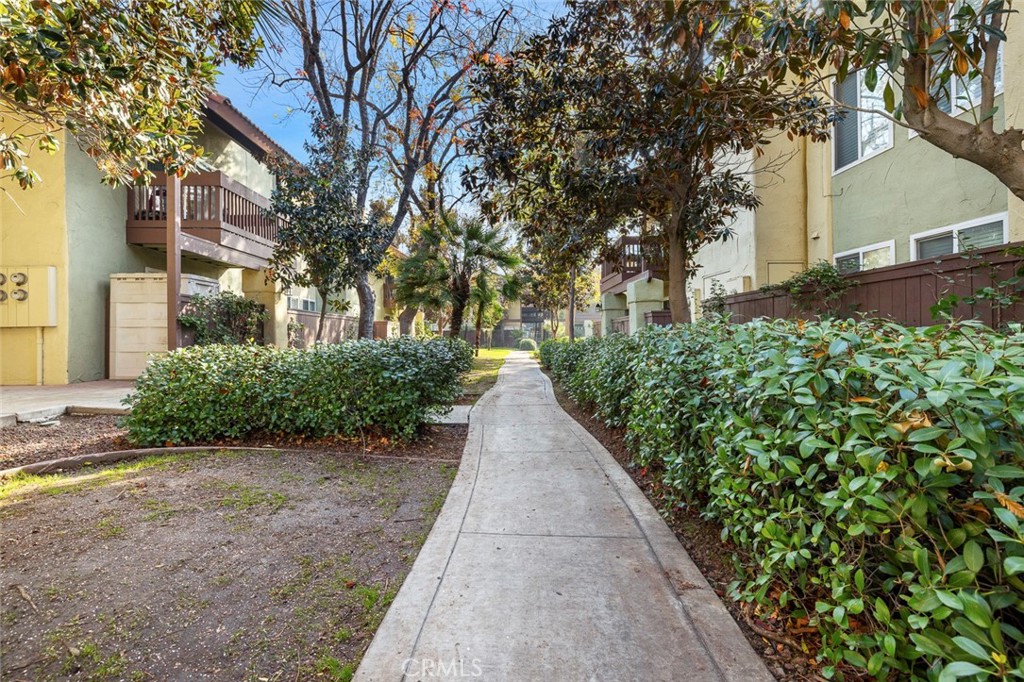 2881 Huntington Boulevard, Unit 137 Fresno, CA 93721 - Photo 23 of 30 a view of a pathway with a wrought fence