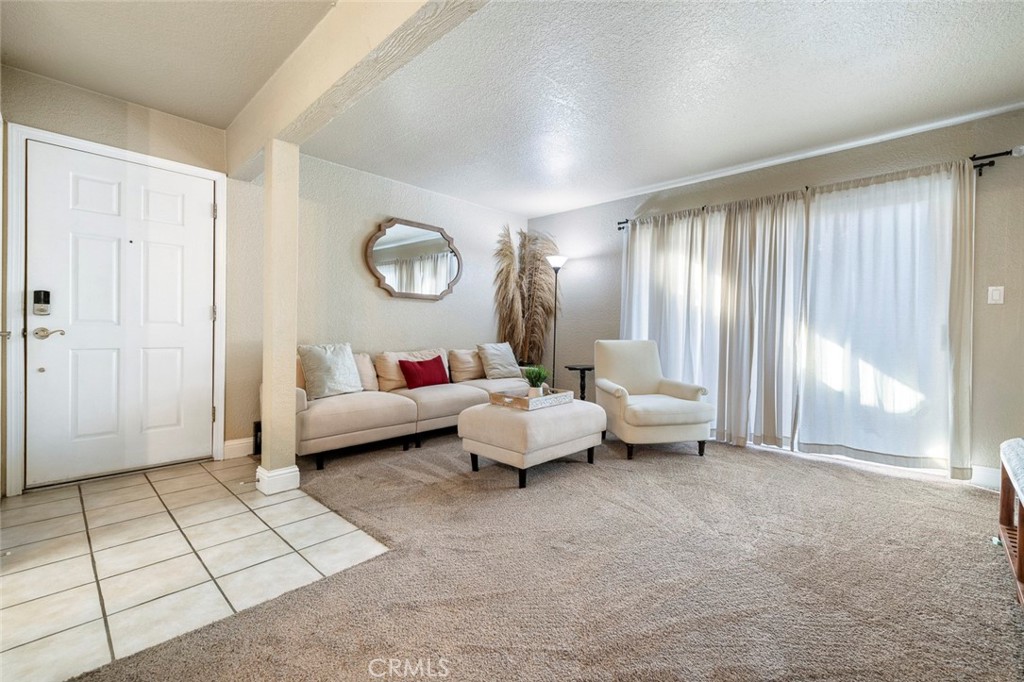 2881 Huntington Boulevard, Unit 137 Fresno, CA 93721 - Photo 4 of 30 a bedroom with furniture and a large window