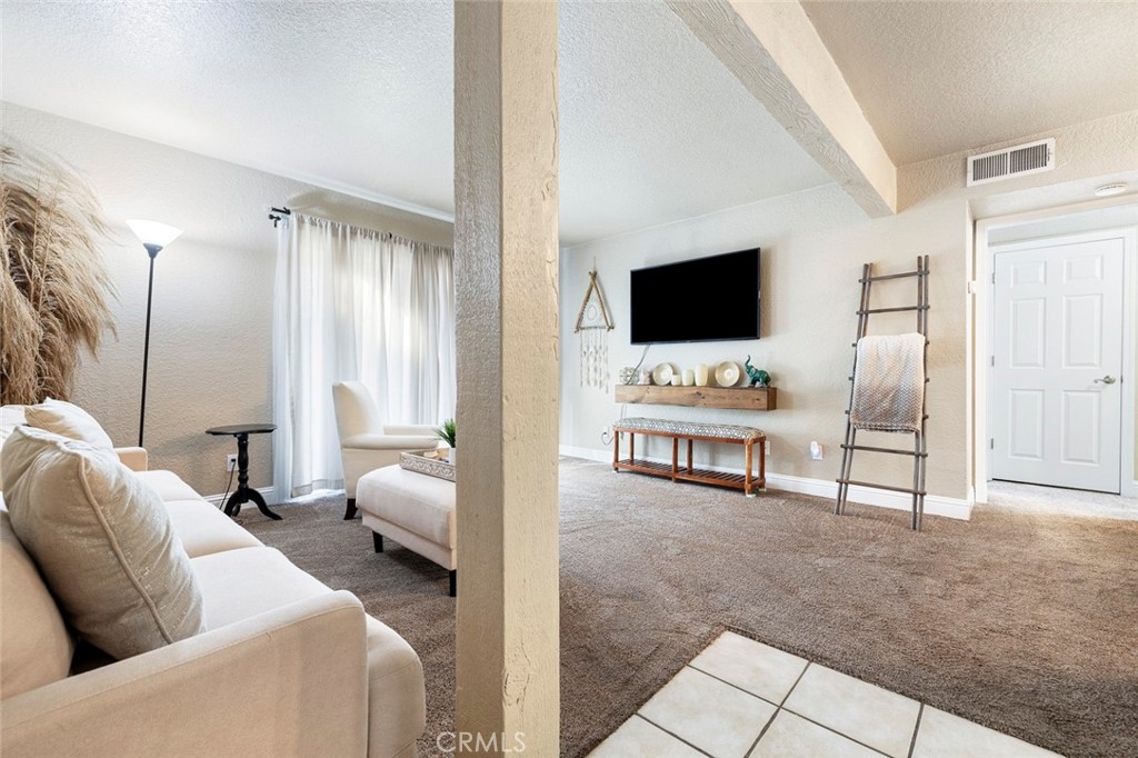 2881 Huntington Boulevard, Unit 137 Fresno, CA 93721 - Photo 6 of 30 a living room with furniture and a flat screen tv