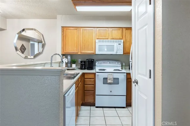 a kitchen with a stove a sink and a window