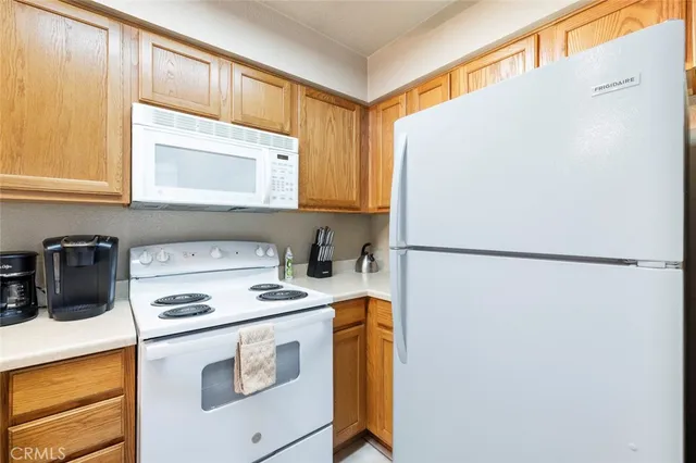 a kitchen with a refrigerator sink stove and cabinets