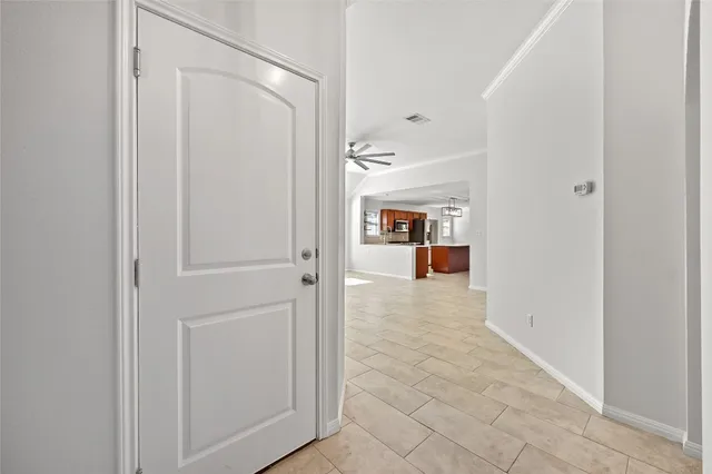 a view of a hallway with a livingroom and a bathroom