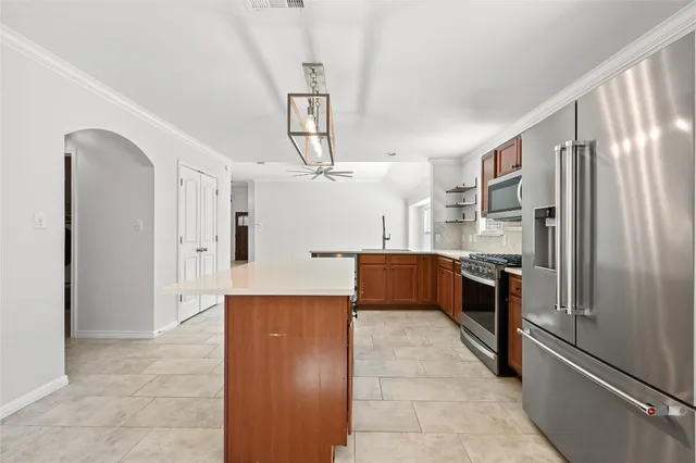 a kitchen with stainless steel appliances a refrigerator and a refrigerator