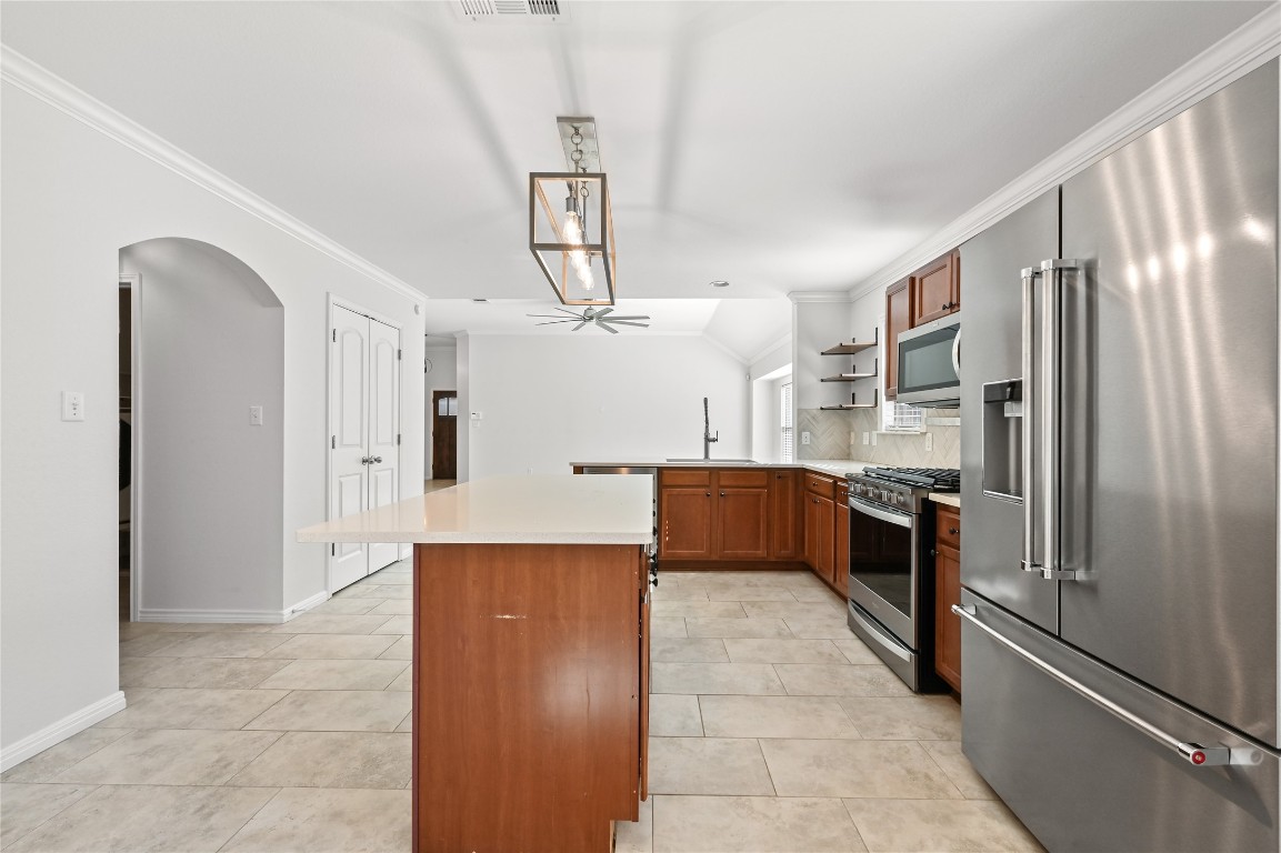 6909 Bay City Bend Austin, TX 78725 - Photo 18 of 37 a kitchen with stainless steel appliances a refrigerator and a refrigerator