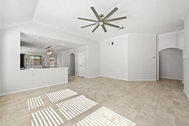 a view of a big room with wooden floor and windows