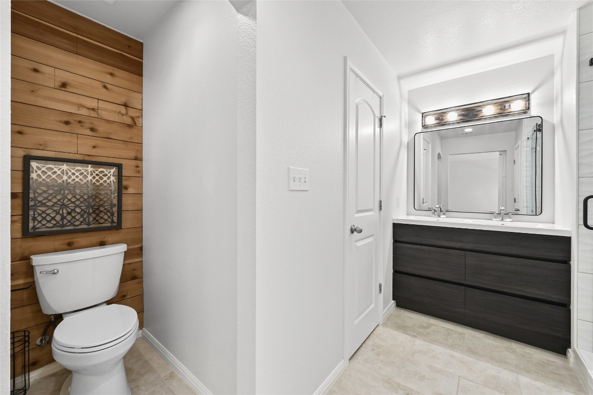 6909 Bay City Bend Austin, TX 78725 - Photo 21 of 37 a bathroom with a toilet sink and mirror