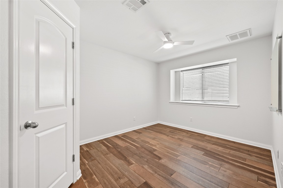 6909 Bay City Bend Austin, TX 78725 - Photo 24 of 37 a view of a room with wooden floor closet and windows