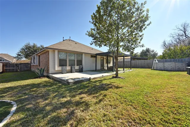 a view of a house with a yard and sitting area