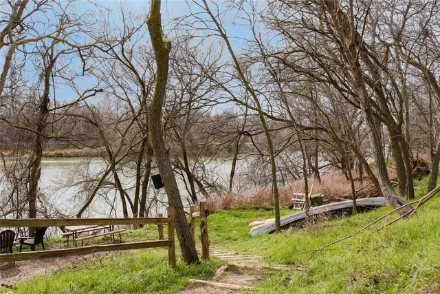 a view of a yard with wooden fence