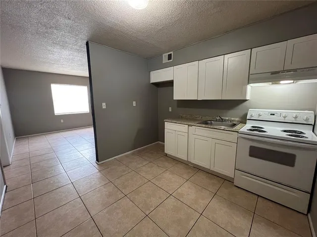 a kitchen with cabinets and white appliances