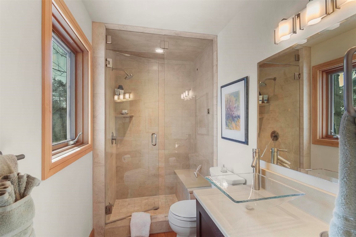 217 South Ridge Street, Unit 3 Breckenridge, CO 80424 - Photo 15 of 21 a bathroom with a granite countertop sink toilet a large mirror and shower