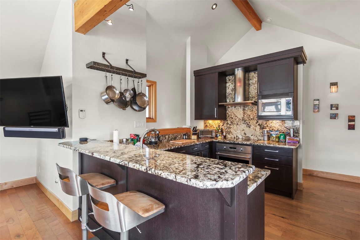 217 South Ridge Street, Unit 3 Breckenridge, CO 80424 - Photo 3 of 21 a kitchen with a stove and a flat screen tv