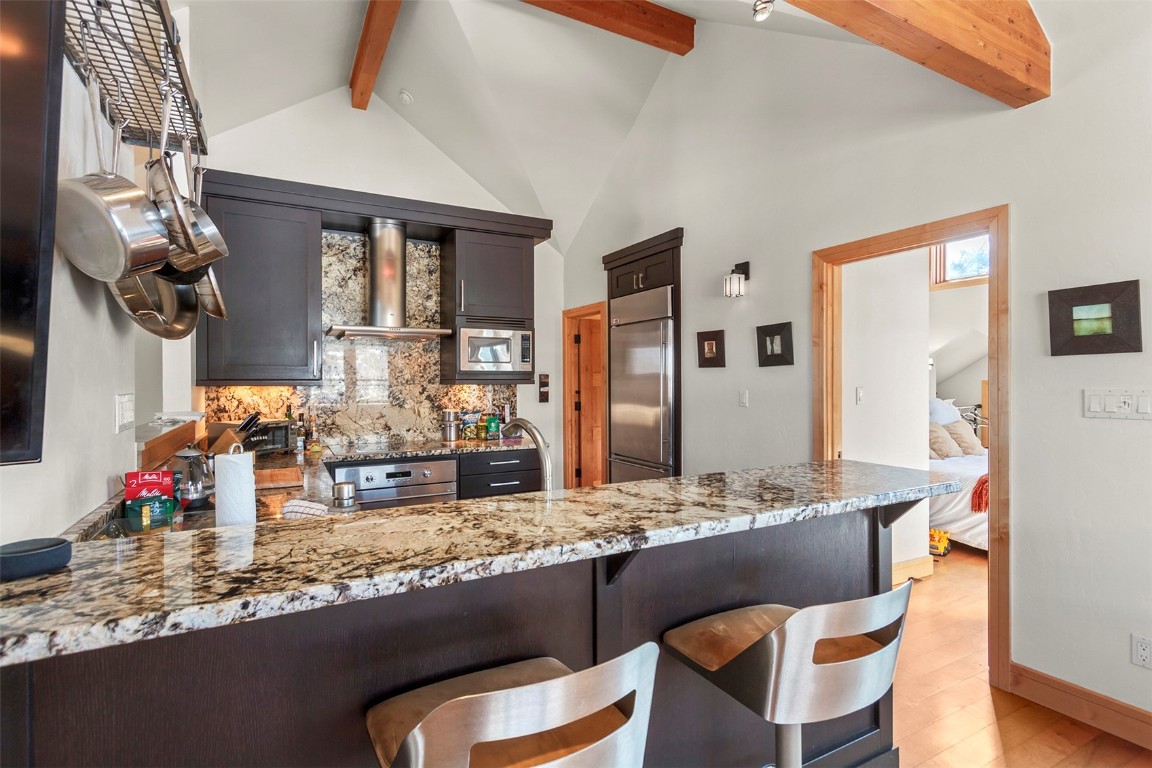 217 South Ridge Street, Unit 3 Breckenridge, CO 80424 - Photo 7 of 21 a kitchen with granite countertop a sink and chairs