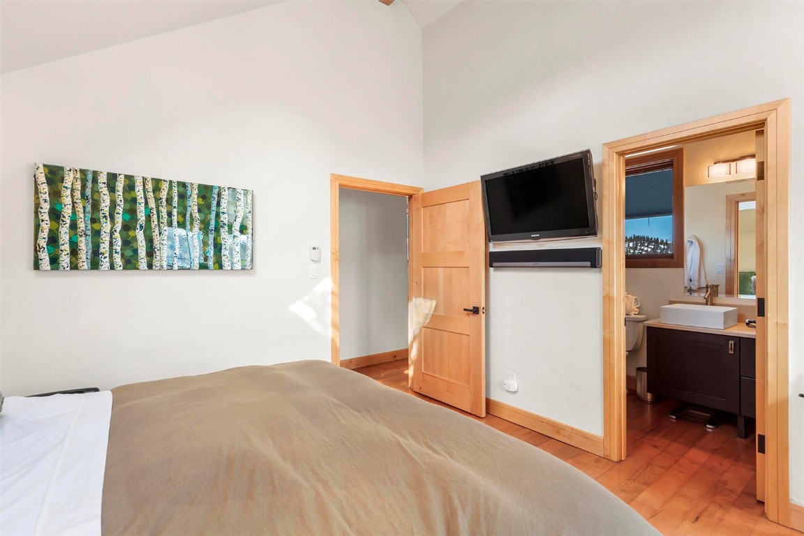 217 South Ridge Street, Unit 3 Breckenridge, CO 80424 - Photo 9 of 21 a bedroom with a bed and a flat screen tv