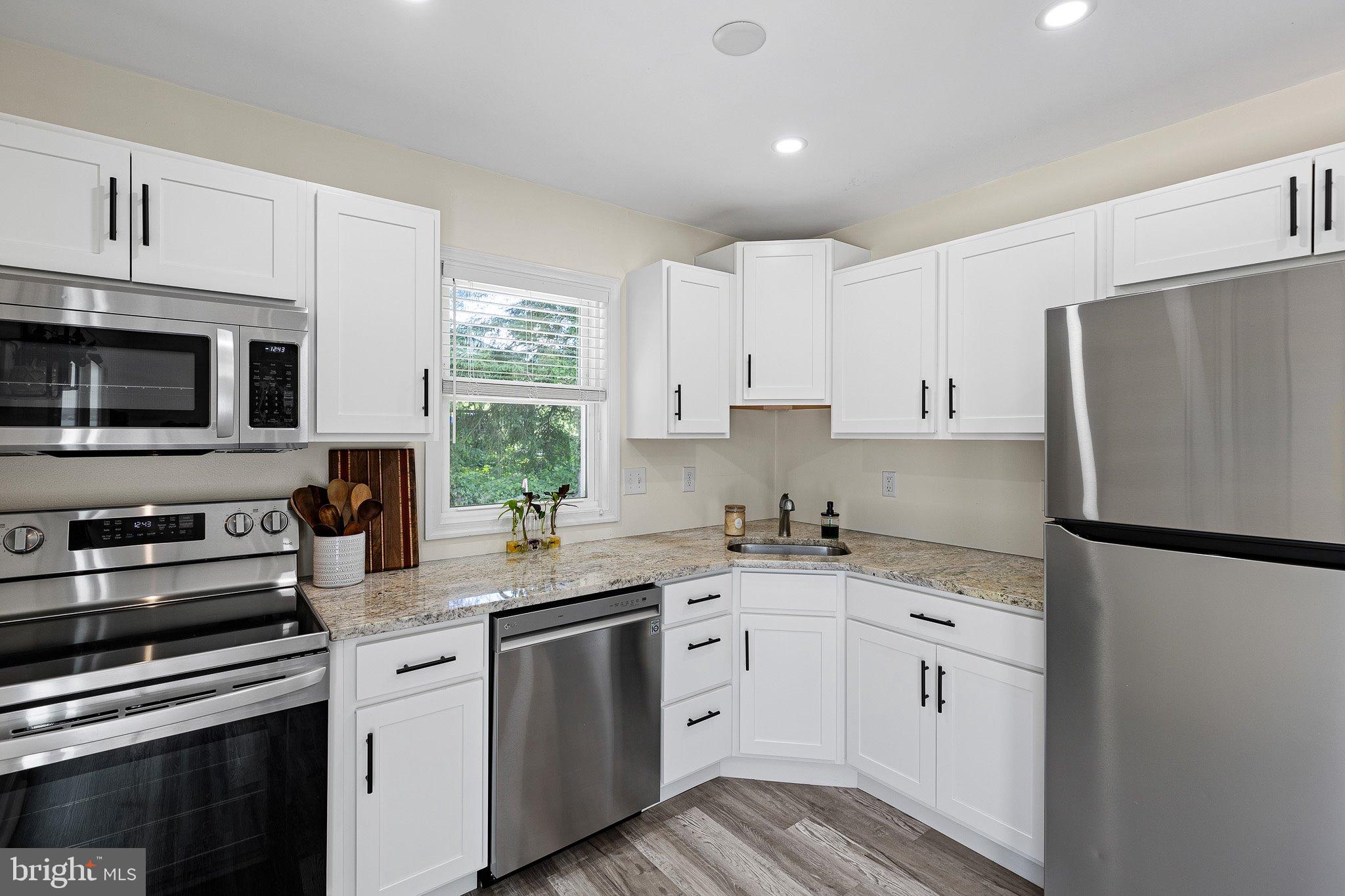 370 Big Elk Chapel Road Elkton, MD 21921 - Photo 9 of 29 a kitchen with stainless steel appliances a sink cabinets and a window